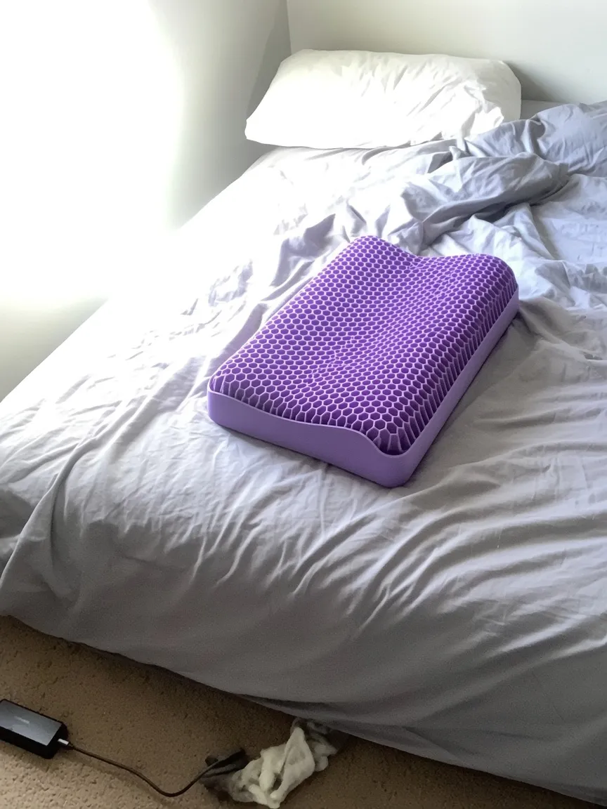 Customer photo of the uncovered purple Latticore pillow on the bed