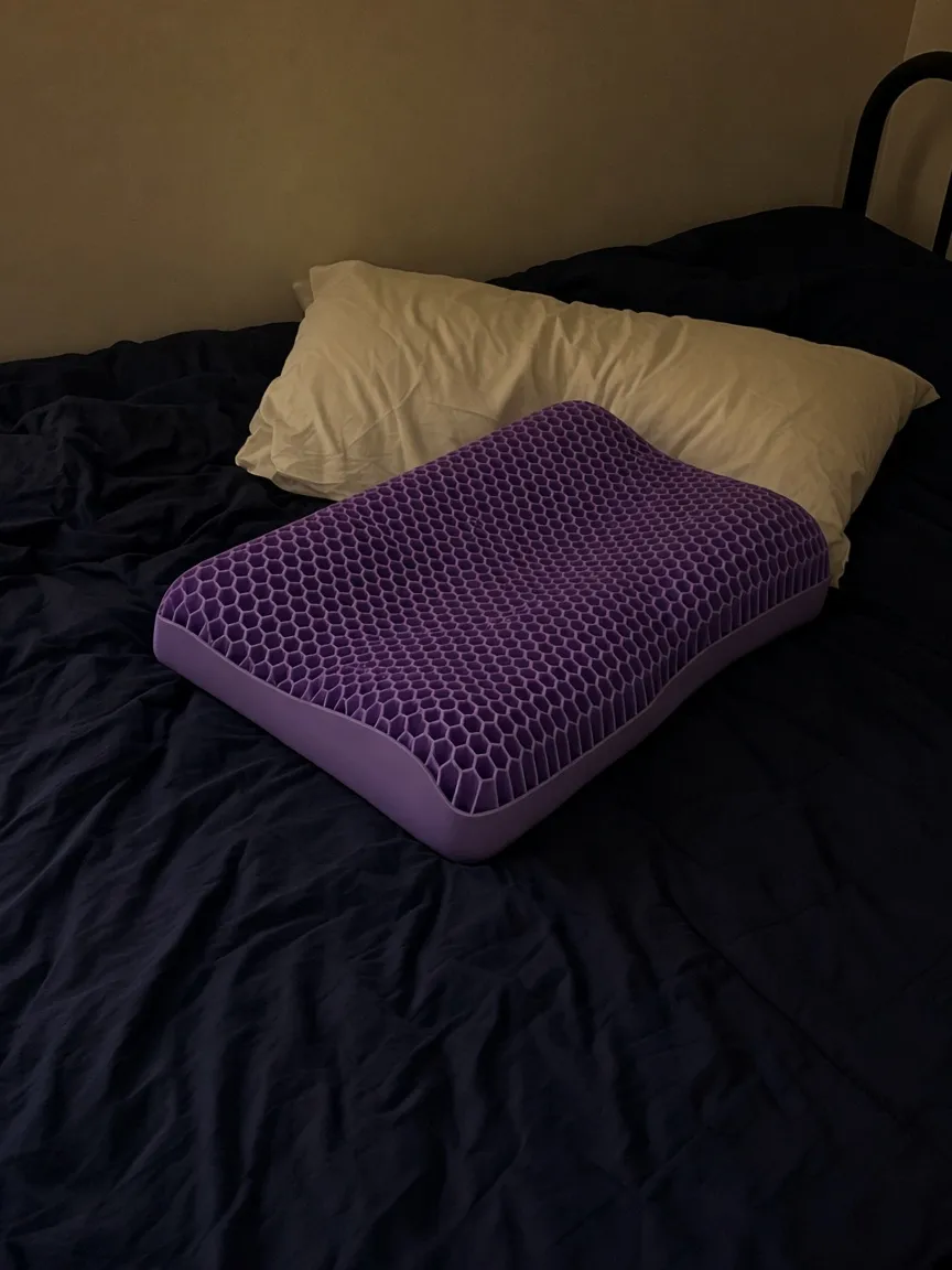 Customer photo of the uncovered purple Latticore pillow in a dim bedroom