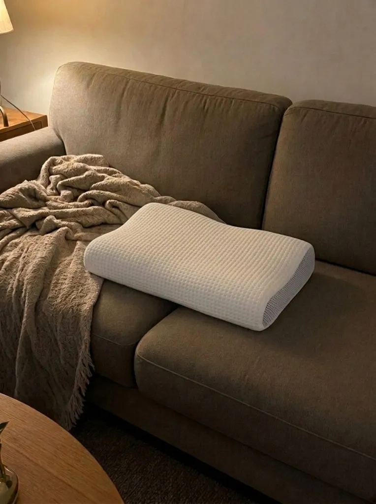 Customer photo of the Latticore pillow in its white cover on a couch